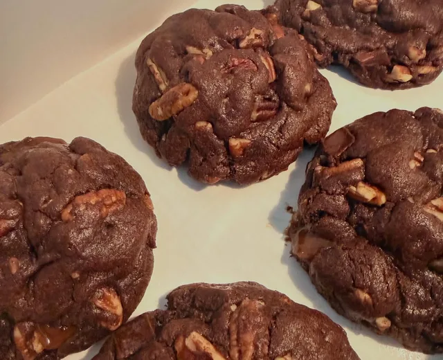 Box of rich chocolate pecan cookies studded with toasted pecan pieces