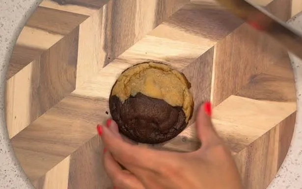 Half-and-half cookie being sliced showing a chocolate side and a classic side